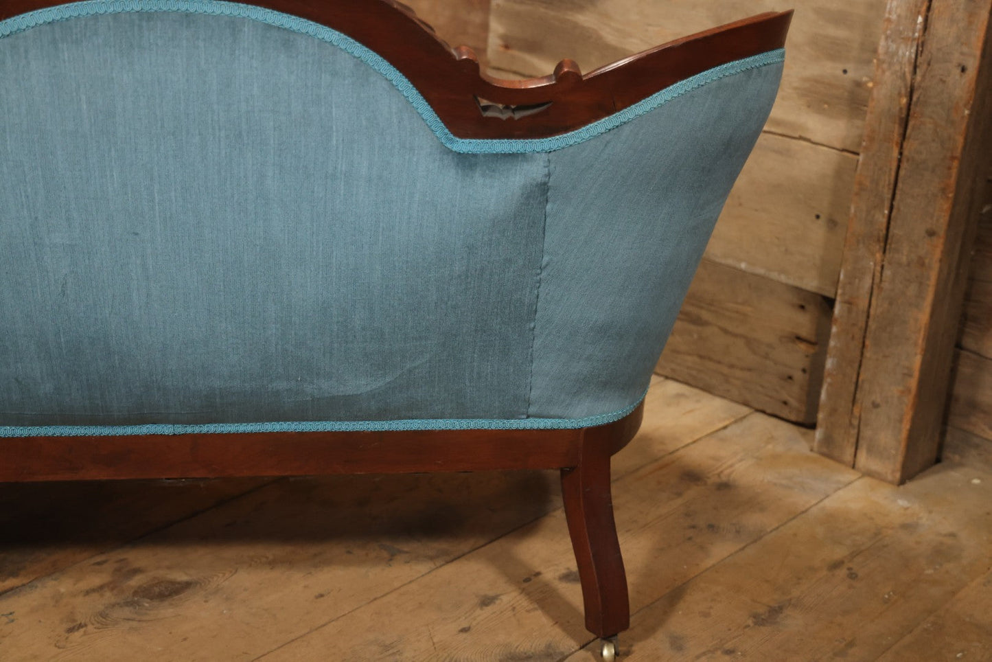 Antique Victorian Carved Walnut Settee With Tufted Blue Upholstery And Casters