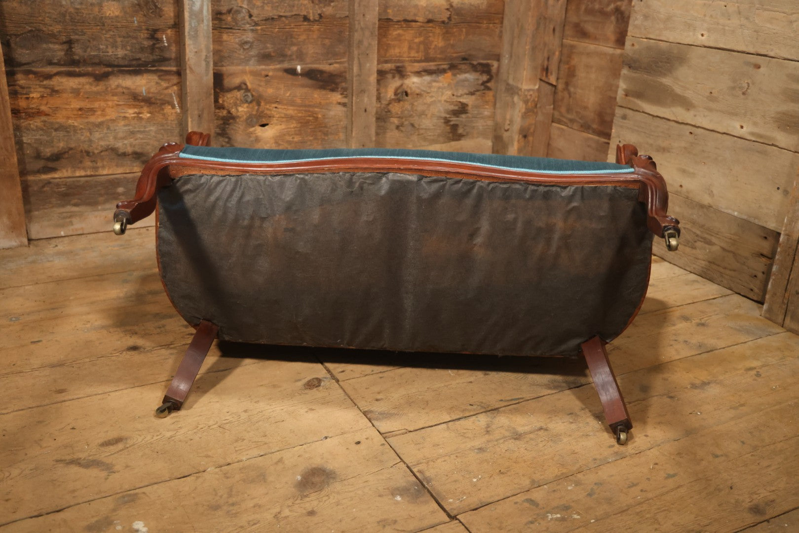 Antique Victorian Carved Walnut Settee With Tufted Blue Upholstery And Casters