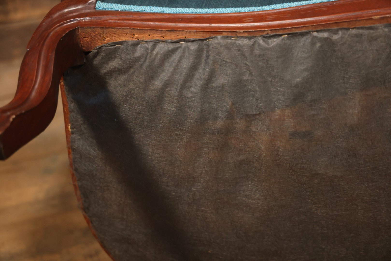 Antique Victorian Carved Walnut Settee With Tufted Blue Upholstery And Casters