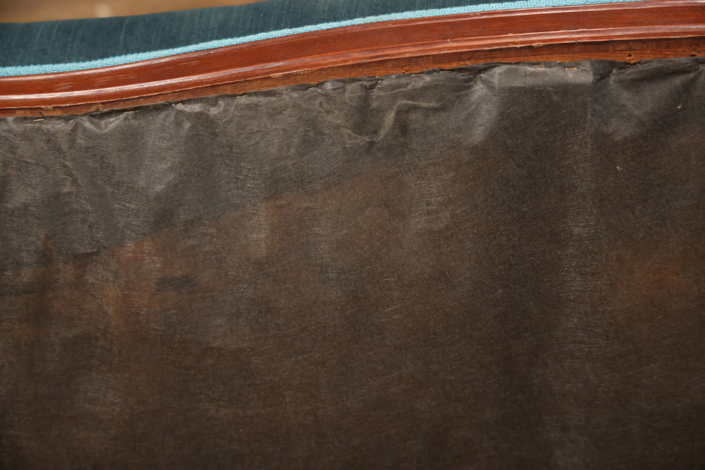 Antique Victorian Carved Walnut Settee With Tufted Blue Upholstery And Casters