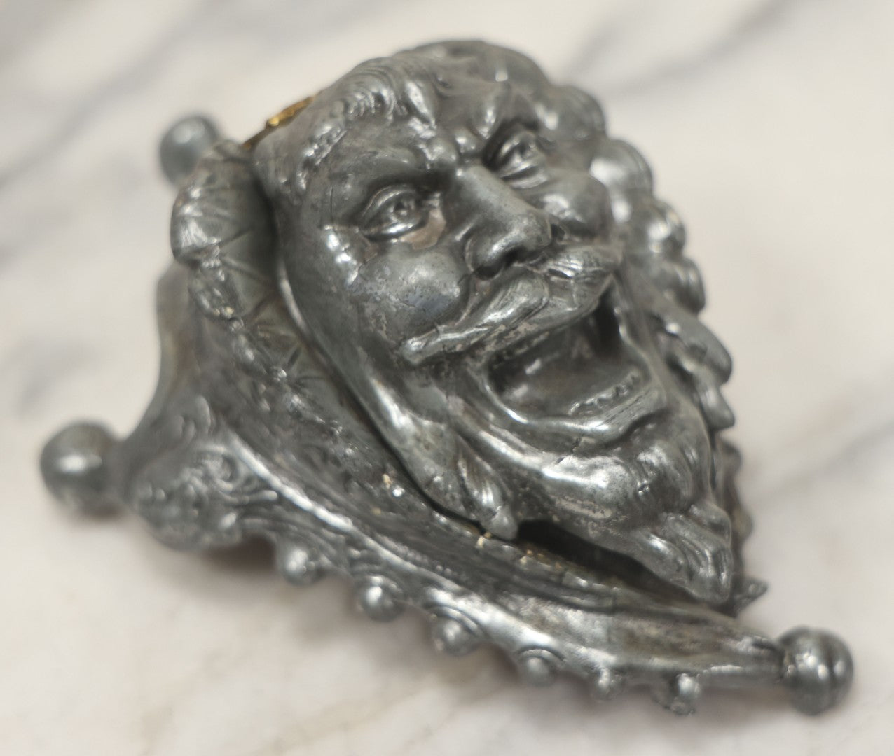 Lot 007 - Antique Pewter Figural Inkwell With Jester Head Motif And Glass Insert, Note Damaged Foot