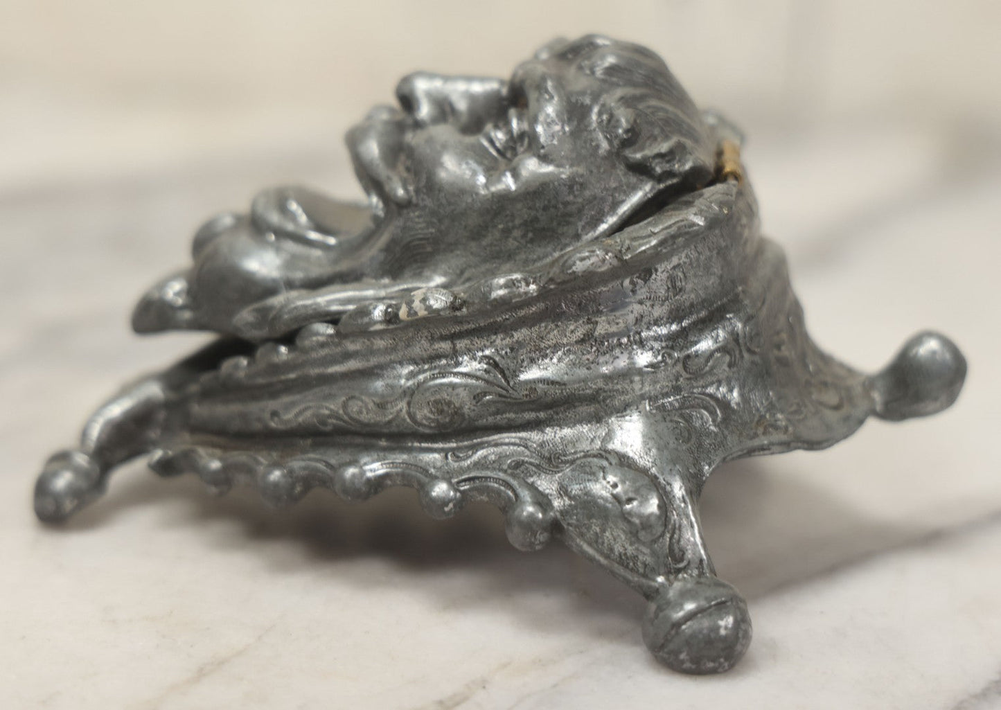 Lot 007 - Antique Pewter Figural Inkwell With Jester Head Motif And Glass Insert, Note Damaged Foot