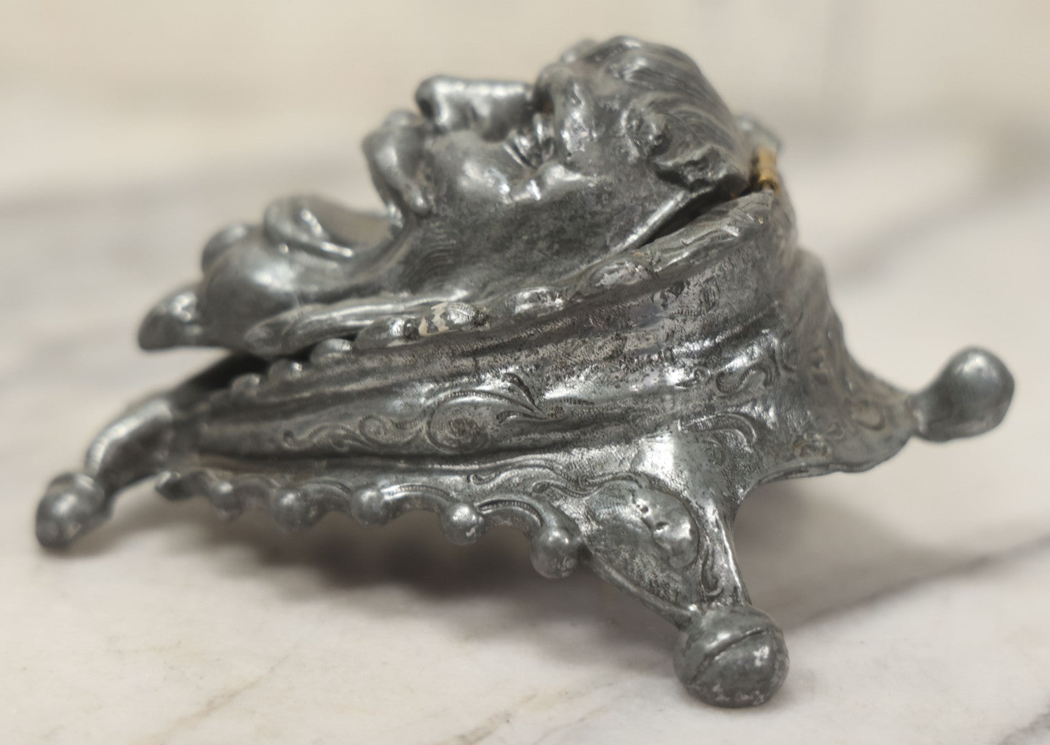 Lot 007 - Antique Pewter Figural Inkwell With Jester Head Motif And Glass Insert, Note Damaged Foot