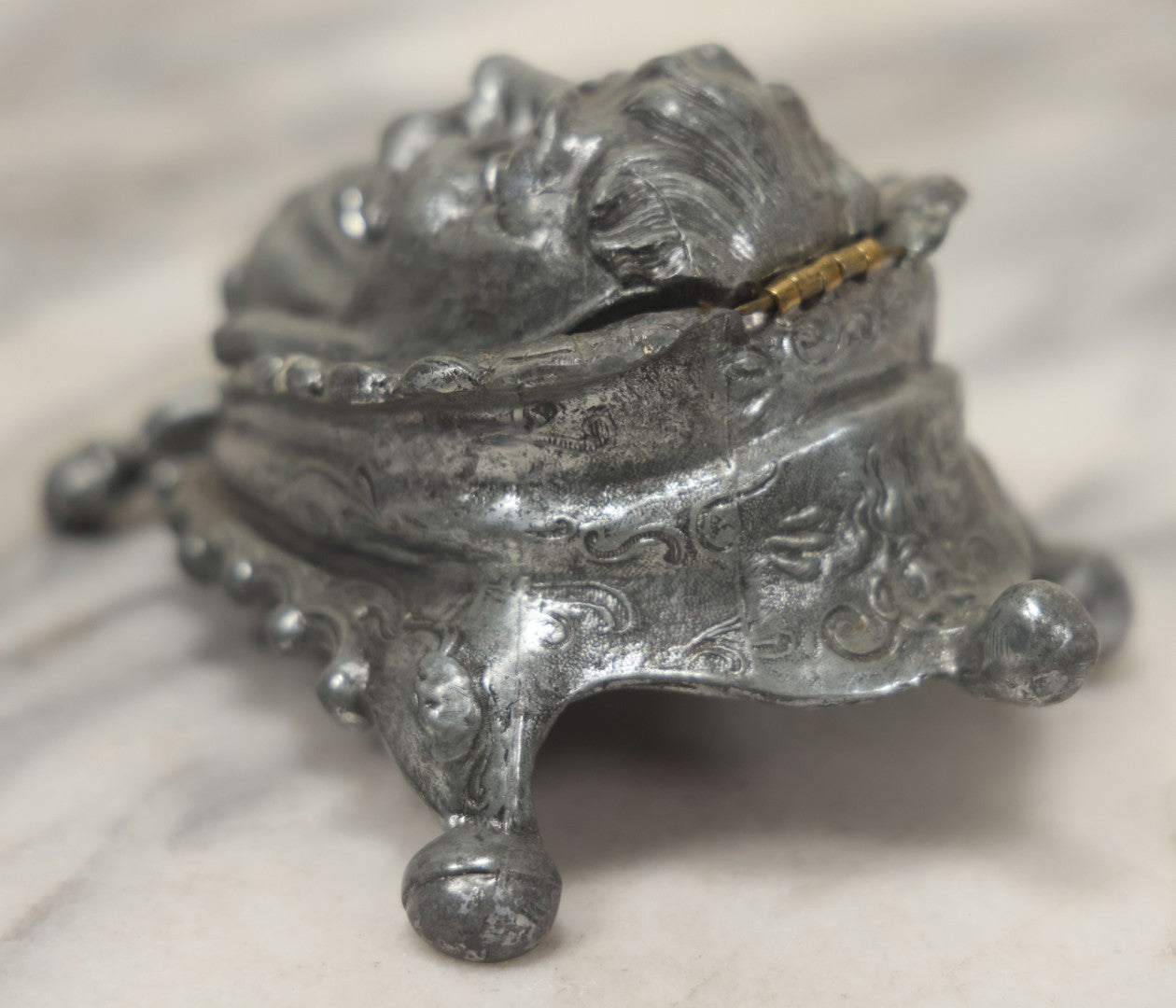 Lot 007 - Antique Pewter Figural Inkwell With Jester Head Motif And Glass Insert, Note Damaged Foot