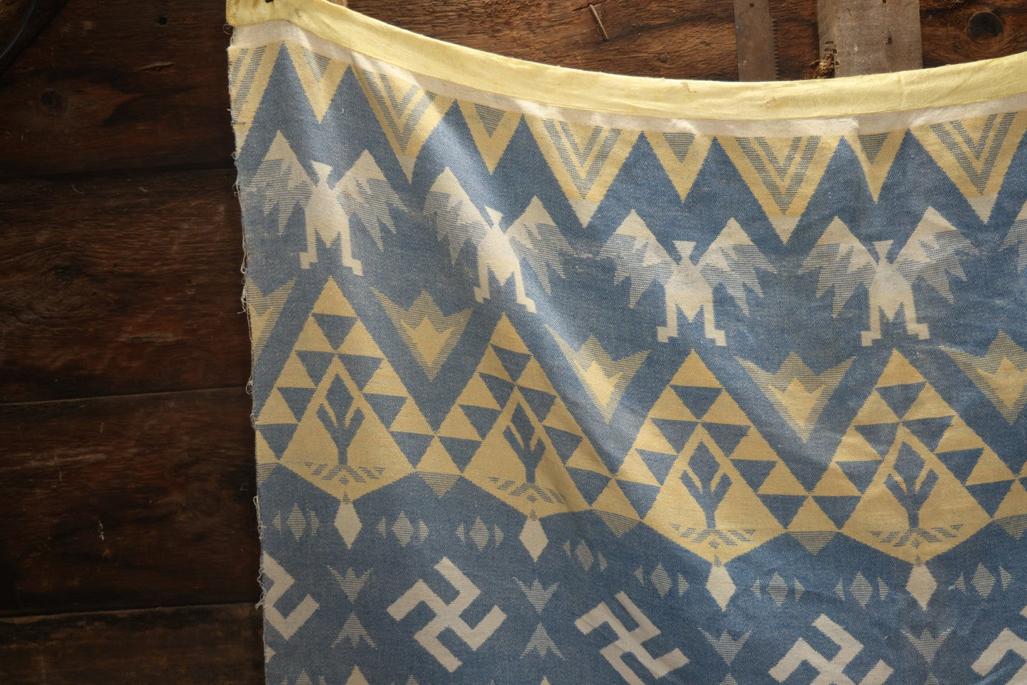 Lot 011 - Vintage Navajo-Style Textile Camp Blanket With Whirling Logs And Thunderbird Motifs, Blue And Yellow, Circa 1920s 60" x 70"
