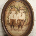 Lot 017 - Antique Sepia Toned Color Tinted Photograph Of Two Brothers In Matching Outfits In Bubble Glass Frame, 14-7/8" x 19-7/8"