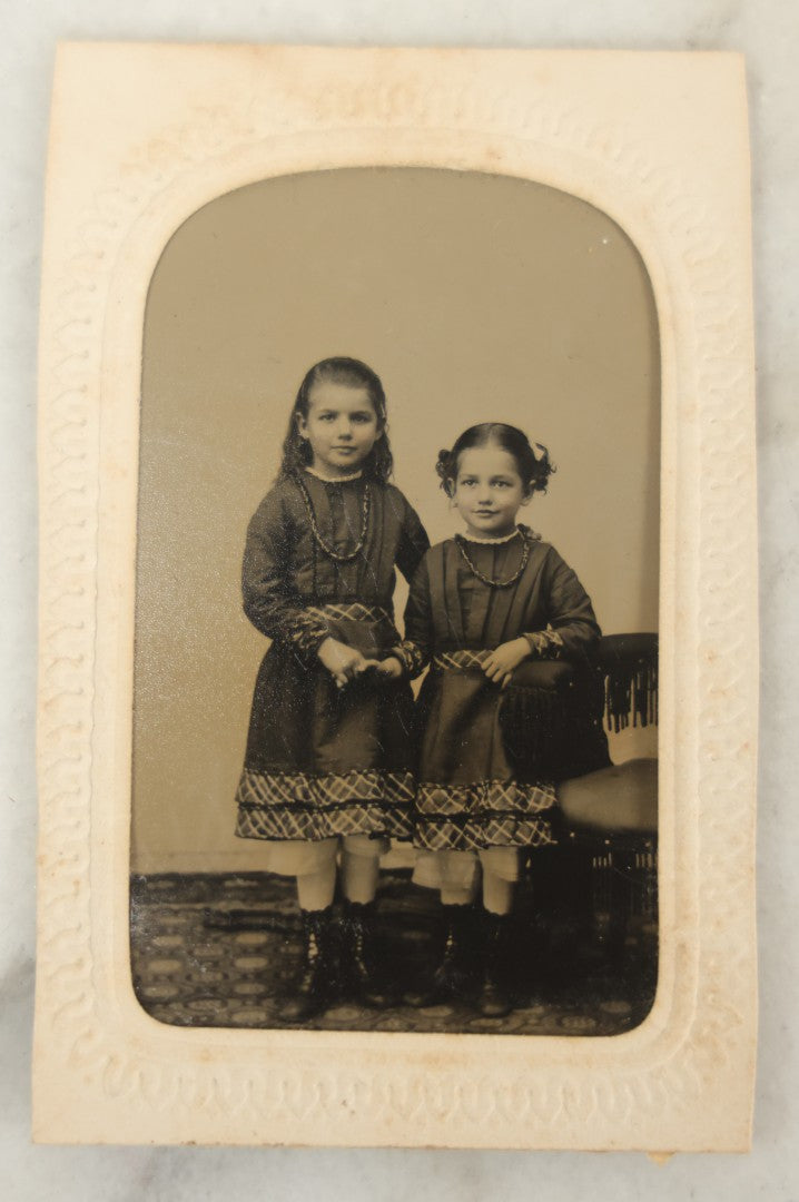 Lot 018 - Antique Tintype Photograph Of Two Smiling Sisters In Matching Outfits Holding Hands, In Paper Frame, Photographed By A.E. Alden, Springfield, Massachusetts