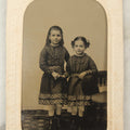 Lot 018 - Antique Tintype Photograph Of Two Smiling Sisters In Matching Outfits Holding Hands, In Paper Frame, Photographed By A.E. Alden, Springfield, Massachusetts