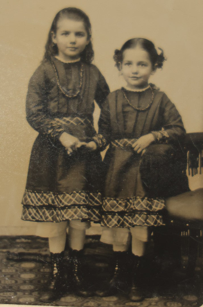 Lot 018 - Antique Tintype Photograph Of Two Smiling Sisters In Matching Outfits Holding Hands, In Paper Frame, Photographed By A.E. Alden, Springfield, Massachusetts