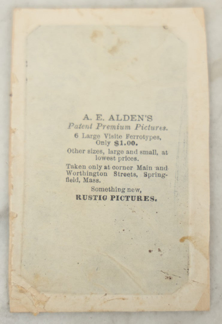 Lot 018 - Antique Tintype Photograph Of Two Smiling Sisters In Matching Outfits Holding Hands, In Paper Frame, Photographed By A.E. Alden, Springfield, Massachusetts