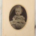 Lot 019 - Antique Not-So-Hidden Mother Tintype Photograph Of A Blonde Toddler In Striped Dress With Mother's Hand, Chin Visible, In Paper Frame