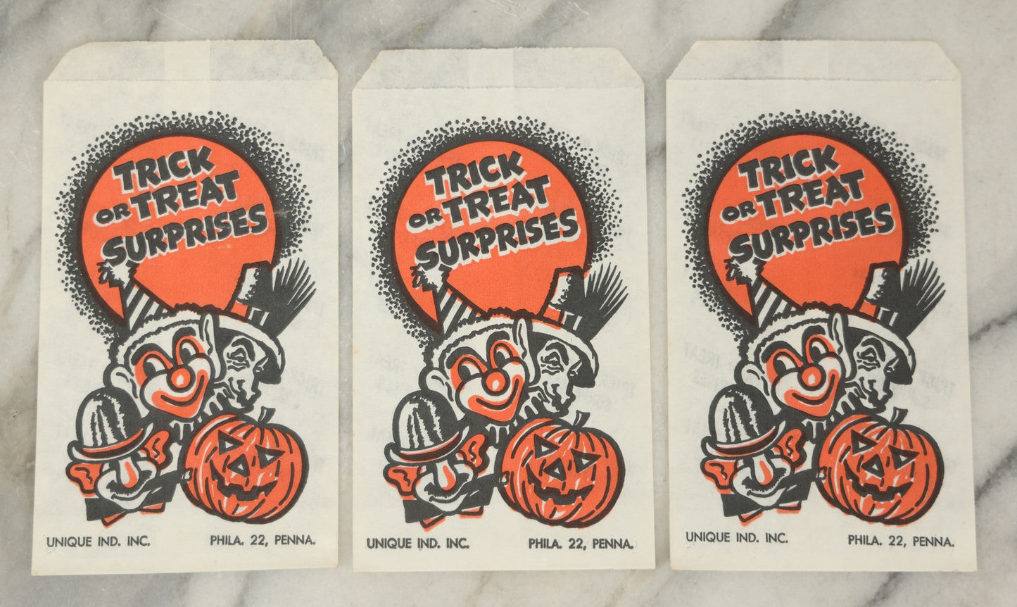 Lot 037 - Grouping Of Three N.O.S. New Old Stock Vintage Halloween Trick-Or-Treat Bags With Clown, Jack O'Lantern, And Costume Characters, “Trick Or Treat Surprises,” Unique Industries Inc., Philadelphia