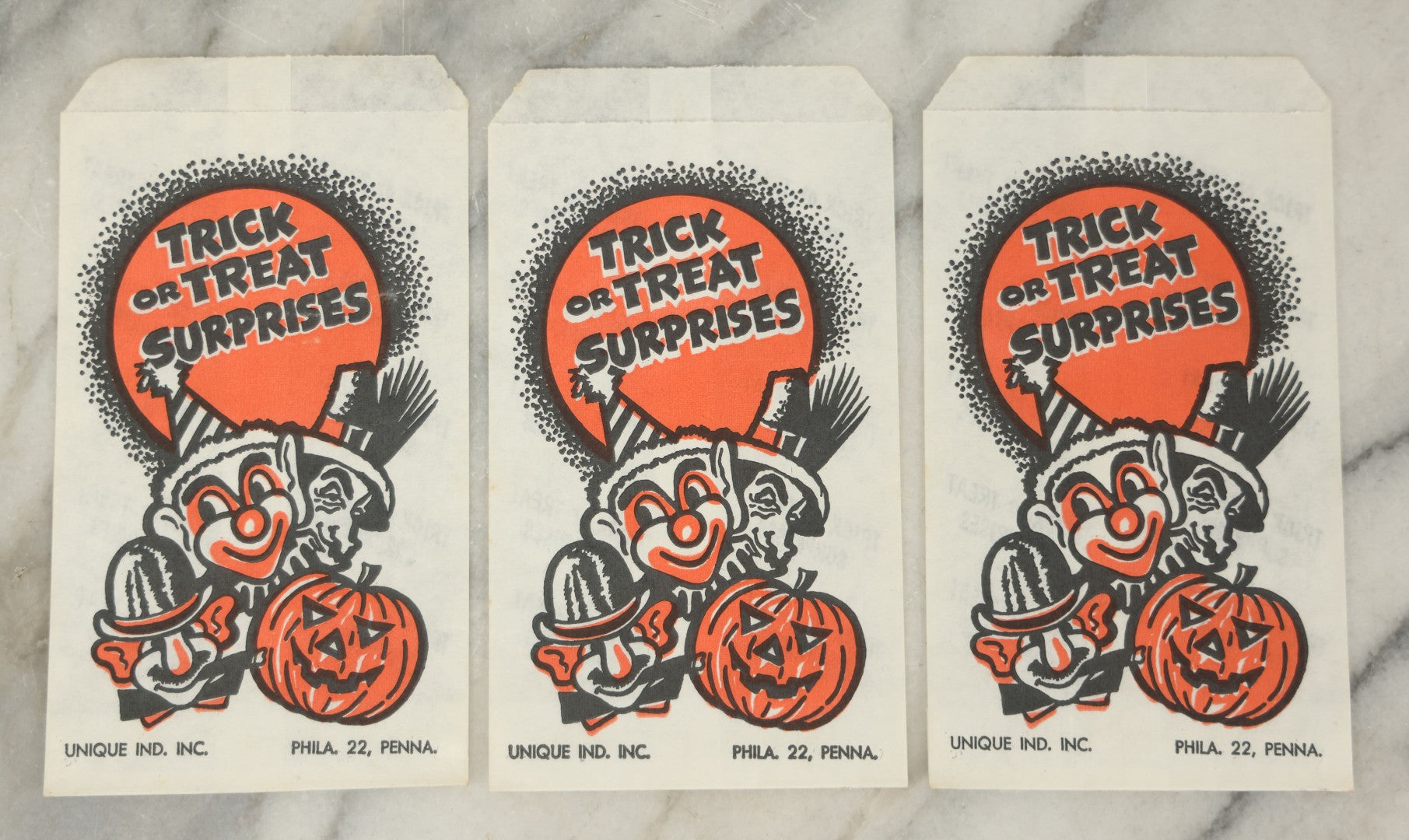 Lot 037 - Grouping Of Three N.O.S. New Old Stock Vintage Halloween Trick-Or-Treat Bags With Clown, Jack O'Lantern, And Costume Characters, “Trick Or Treat Surprises,” Unique Industries Inc., Philadelphia