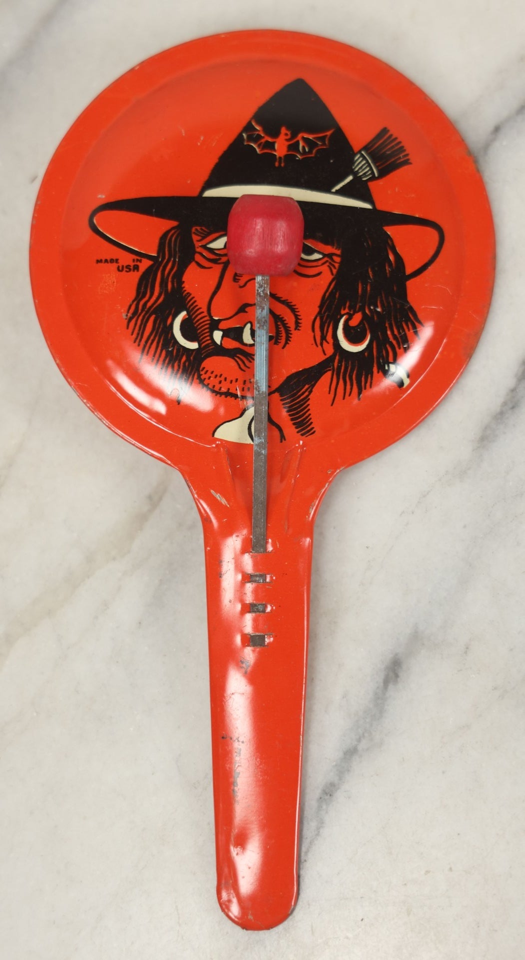 Lot 041 - Vintage Tin Lithograph Halloween Noisemaker With Snaggle-Toothed Witch On Orange Background, Made In U.S.A., 8-1/4" L