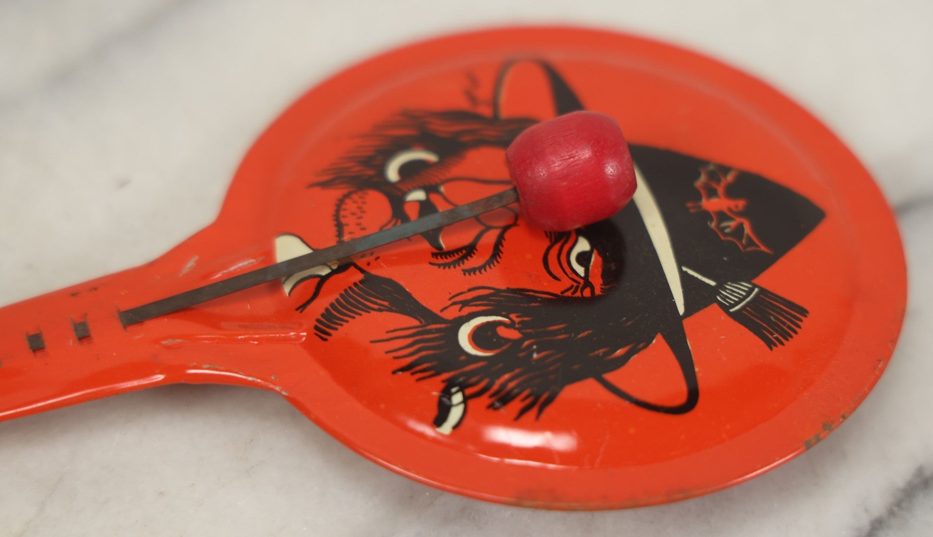 Lot 041 - Vintage Tin Lithograph Halloween Noisemaker With Snaggle-Toothed Witch On Orange Background, Made In U.S.A., 8-1/4" L