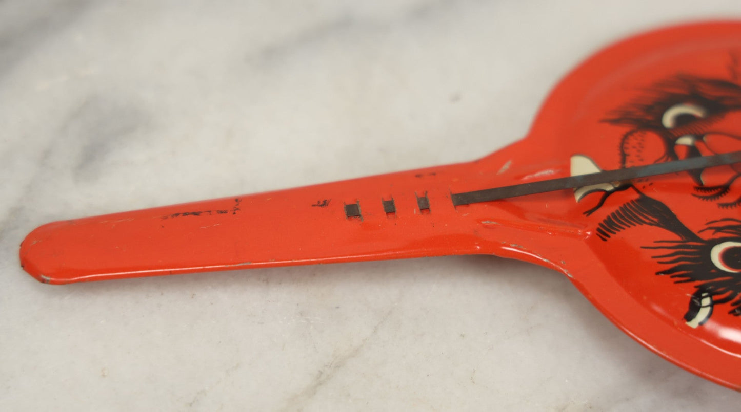 Lot 041 - Vintage Tin Lithograph Halloween Noisemaker With Snaggle-Toothed Witch On Orange Background, Made In U.S.A., 8-1/4" L