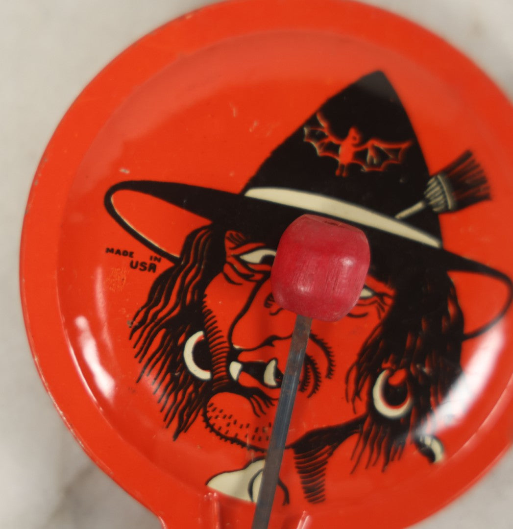 Lot 041 - Vintage Tin Lithograph Halloween Noisemaker With Snaggle-Toothed Witch On Orange Background, Made In U.S.A., 8-1/4" L