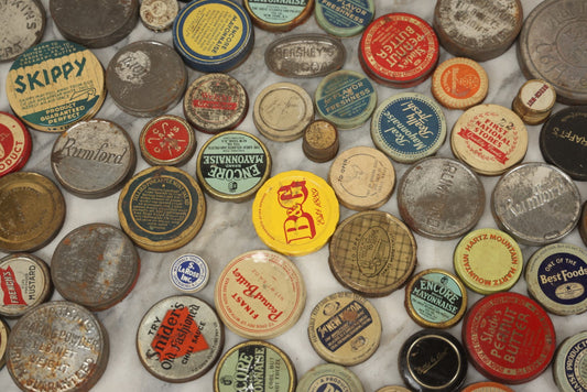 Lot 080 - Grouping Of 50+ Vintage And Antique Jar, Tin, And Bottle Lids With Advertising For Various Brands Including Skippy, Encore Mayonnaise, First National Stores, Snider's Chili Sauce, And More, As Found