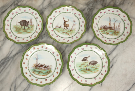 Lot 100 - Grouping Of Five Antique Hand-Colored Transferware Plates Depicting Hunting Game Including Boar, Elk, Hare, Pheasants/Quail, And Turkeys, Marked Bassett Limoges Austria With Hallmark, 8-1/2" Diameter