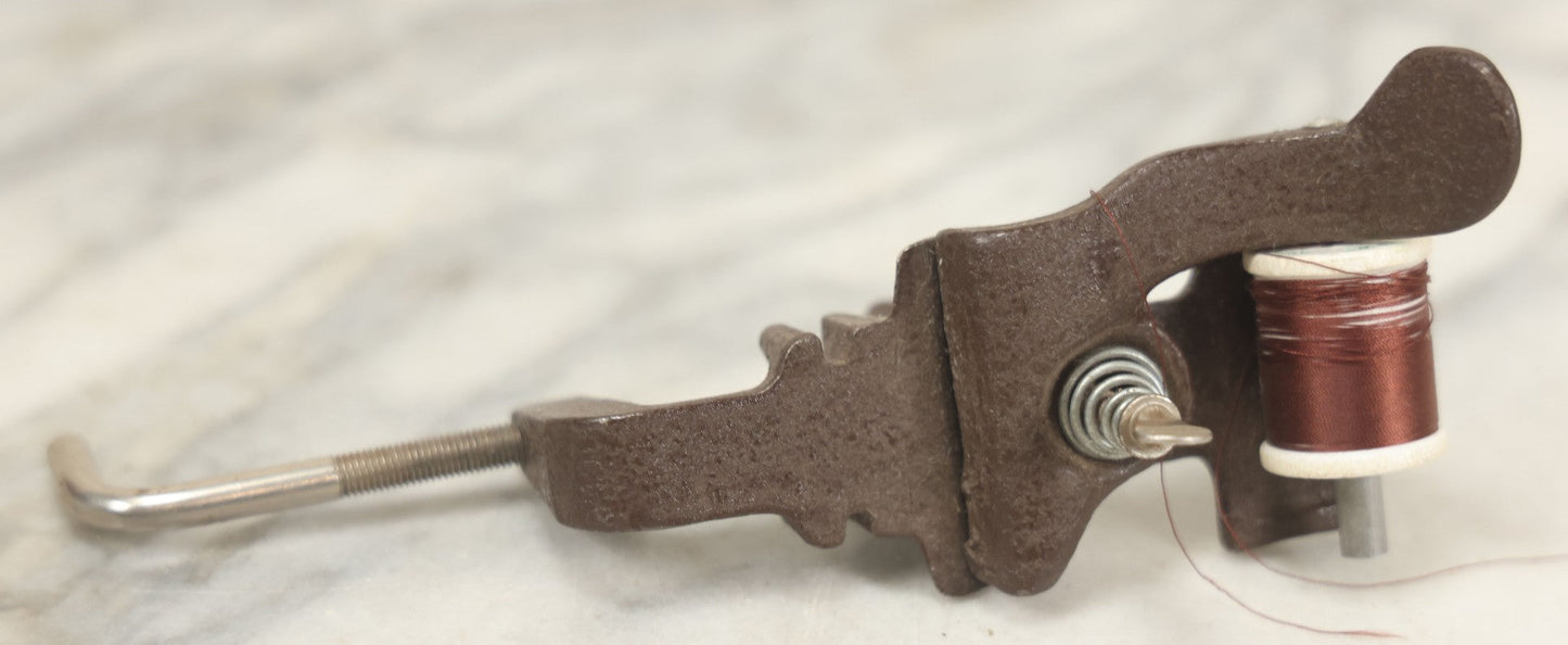 Lot 107 - Antique And Vintage Sewing Lot Including Marbled Plastic Thread Holder With Pin Cushion, Metal Mushroom Thread Holder, Two Thimbles, And Cast Iron Table Clamp Thread Holder By Herter's, Waseca Minn., No. 29