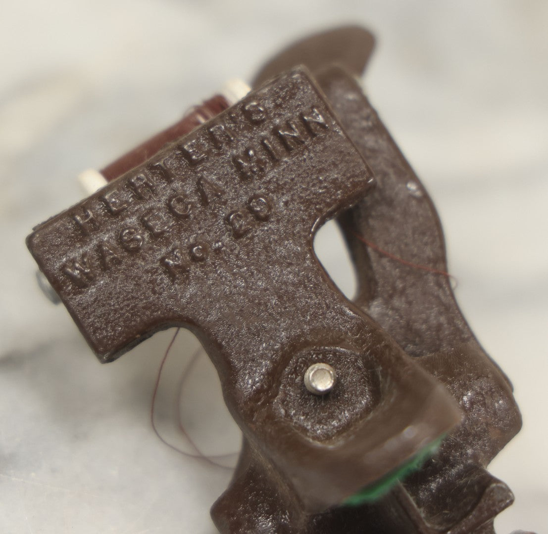 Lot 107 - Antique And Vintage Sewing Lot Including Marbled Plastic Thread Holder With Pin Cushion, Metal Mushroom Thread Holder, Two Thimbles, And Cast Iron Table Clamp Thread Holder By Herter's, Waseca Minn., No. 29