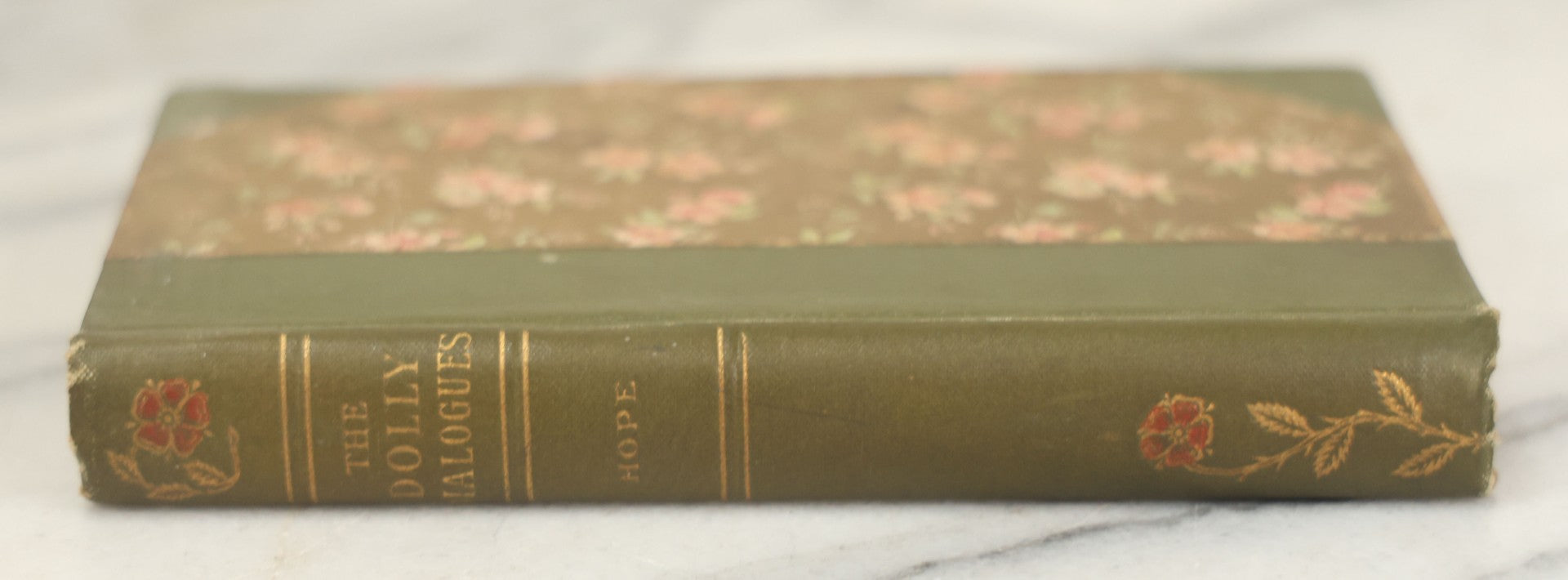 Lot 177 - "The Dolly Dialogues" By Anthony Hope, Undated, Publisher Unknown, Circa 1900s Flower Print And Illustrations On Spine, Pocket Sized