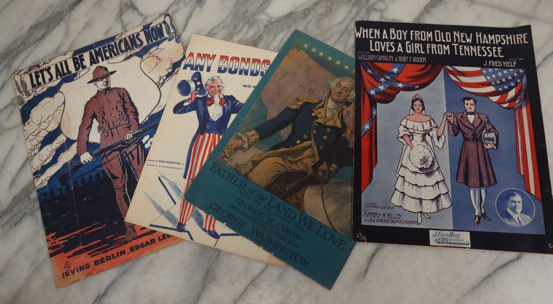 Lot 181 - Grouping Of Four Vintage Patriotic And Popular Sheet Music Covers Including “Let's All Be Americans Now,” “Any Bonds Today?,” “Father Of The Land We Love,” And “When A Boy From Old New Hampshire Loves A Girl From Tennessee”
