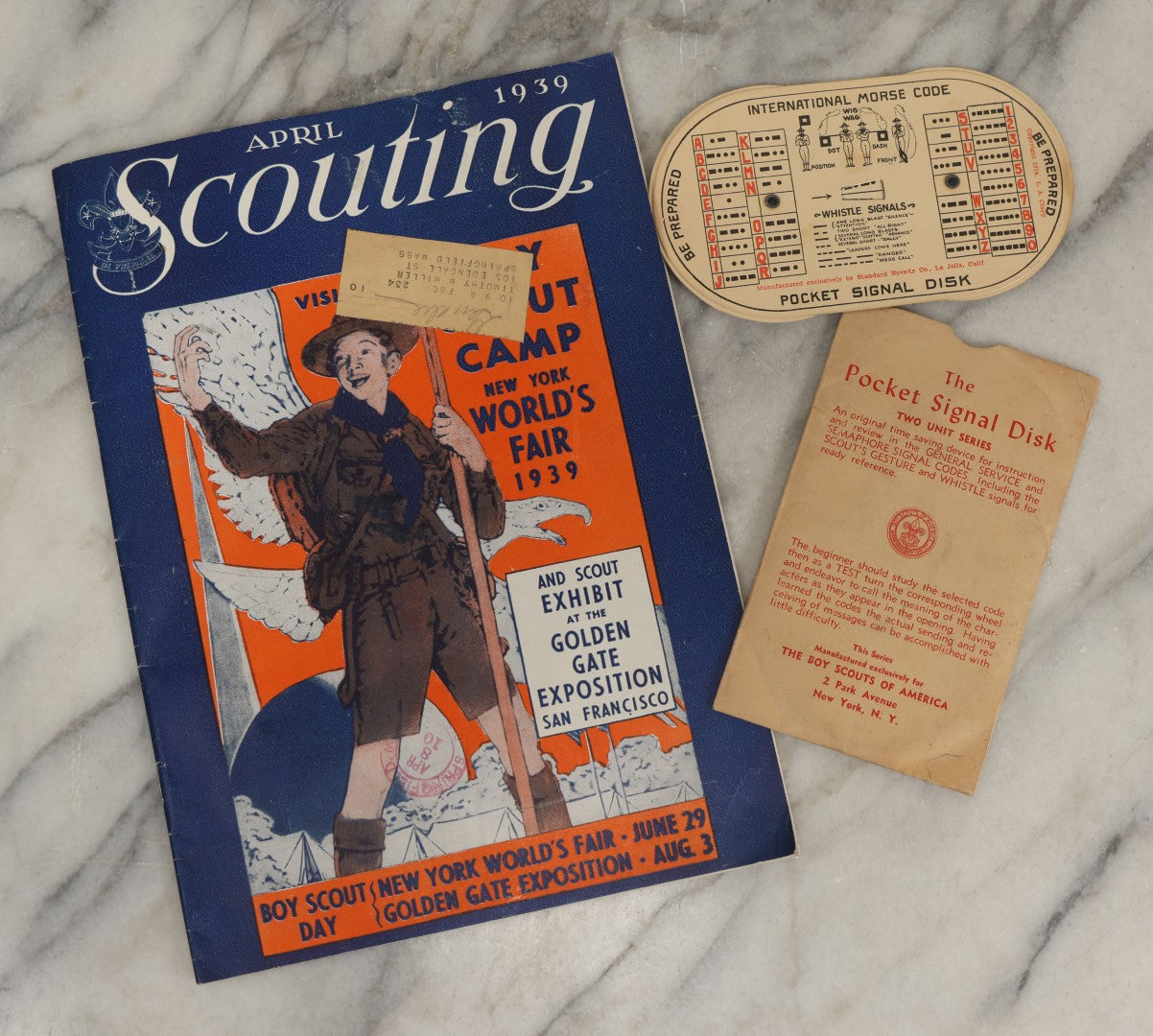 Lot 184 - Pair Of Vintage Boy Scout Items Including April 1939 Scouting Magazine And Pocket Signal Disk With Sleeve