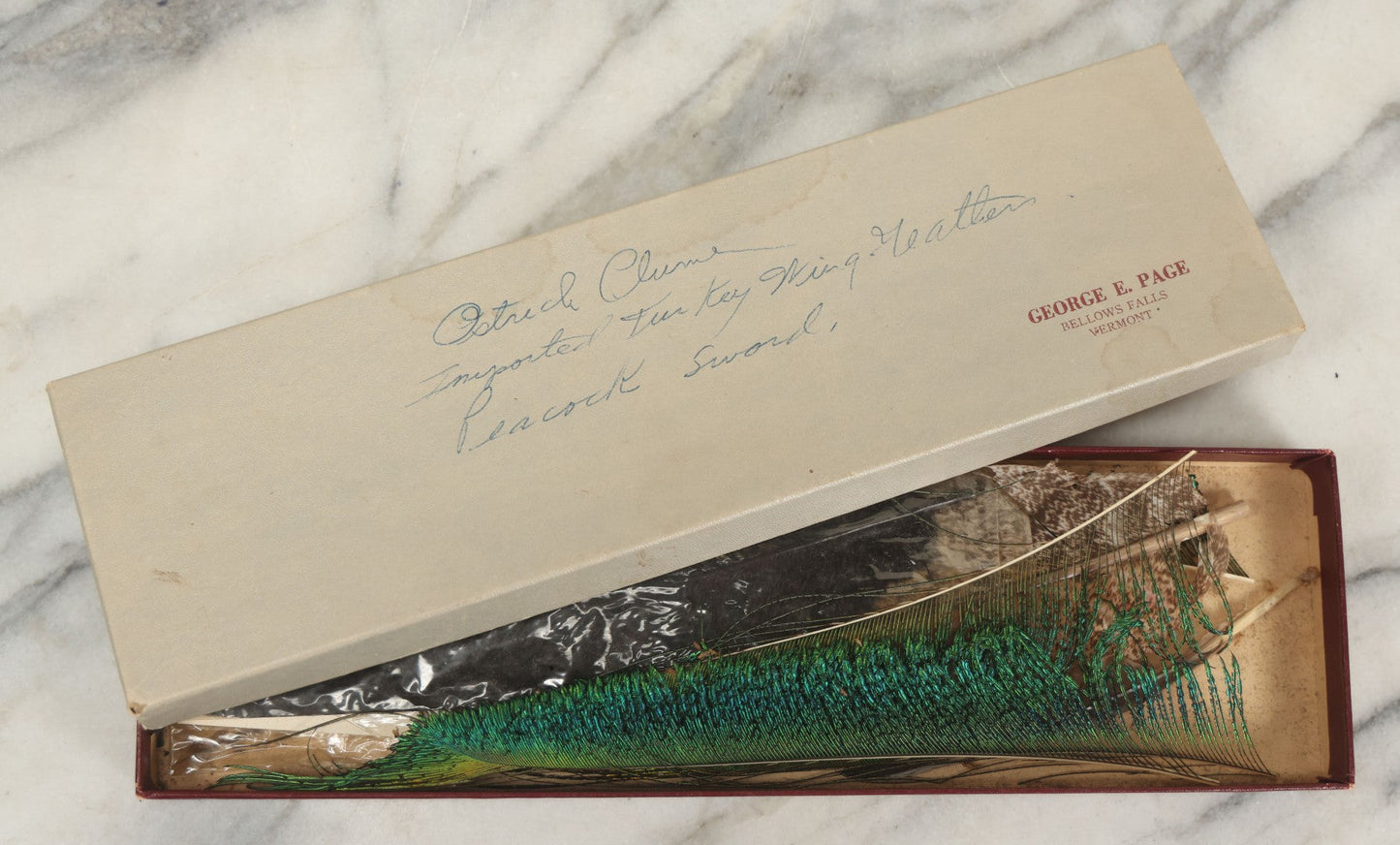 Lot 188 - Boxed Lot Of Antique Decorative Feathers Including Peacock Sword, Ostrich Plume, And Imported Turkey Wing Feathers, In George E. Page Box, Bellows Falls, Vermont, As Found