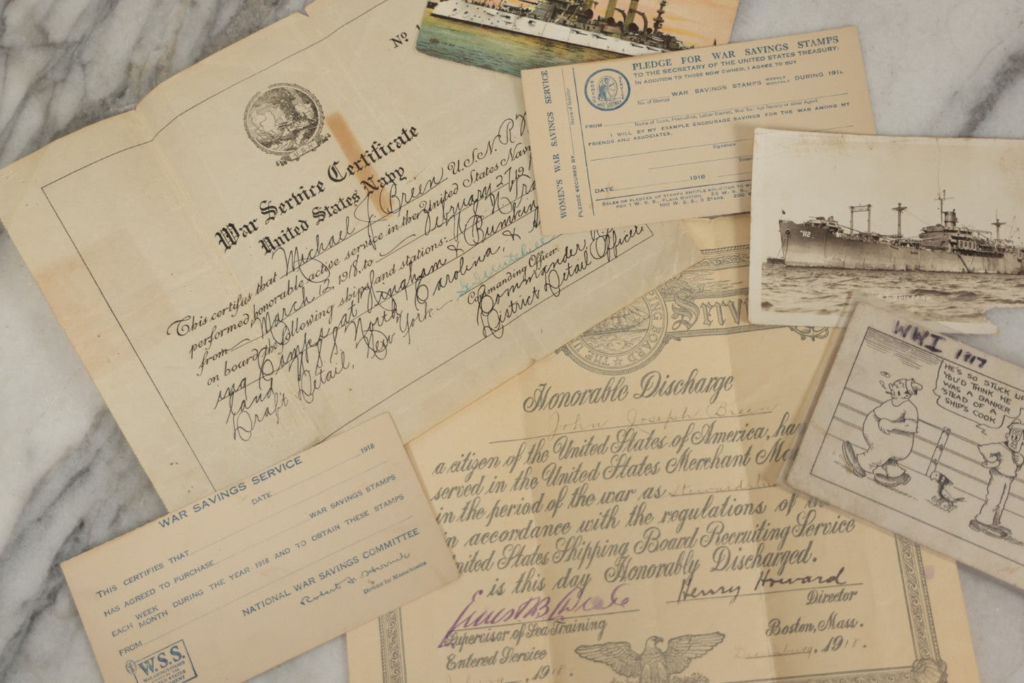Lot 190 - Grouping Of Seven Antique World War I Related Ephemera Items Including Discharge Papers For John Joseph Breen And Michael J. Breen, Comic Postcard, And War Savings Stamps Forms, Circa 1910s–1920s