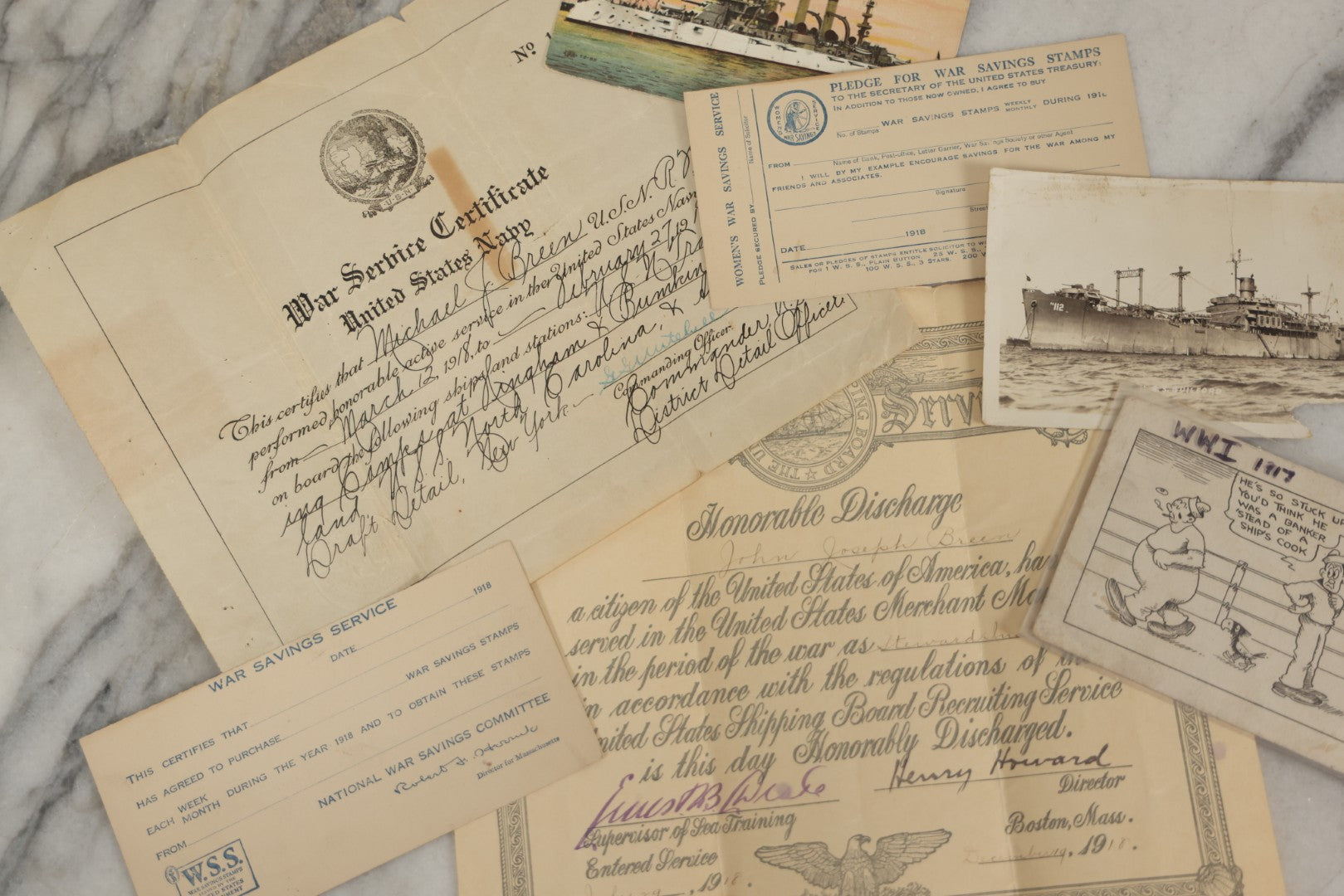 Lot 190 - Grouping Of Seven Antique World War I Related Ephemera Items Including Discharge Papers For John Joseph Breen And Michael J. Breen, Comic Postcard, And War Savings Stamps Forms, Circa 1910s–1920s