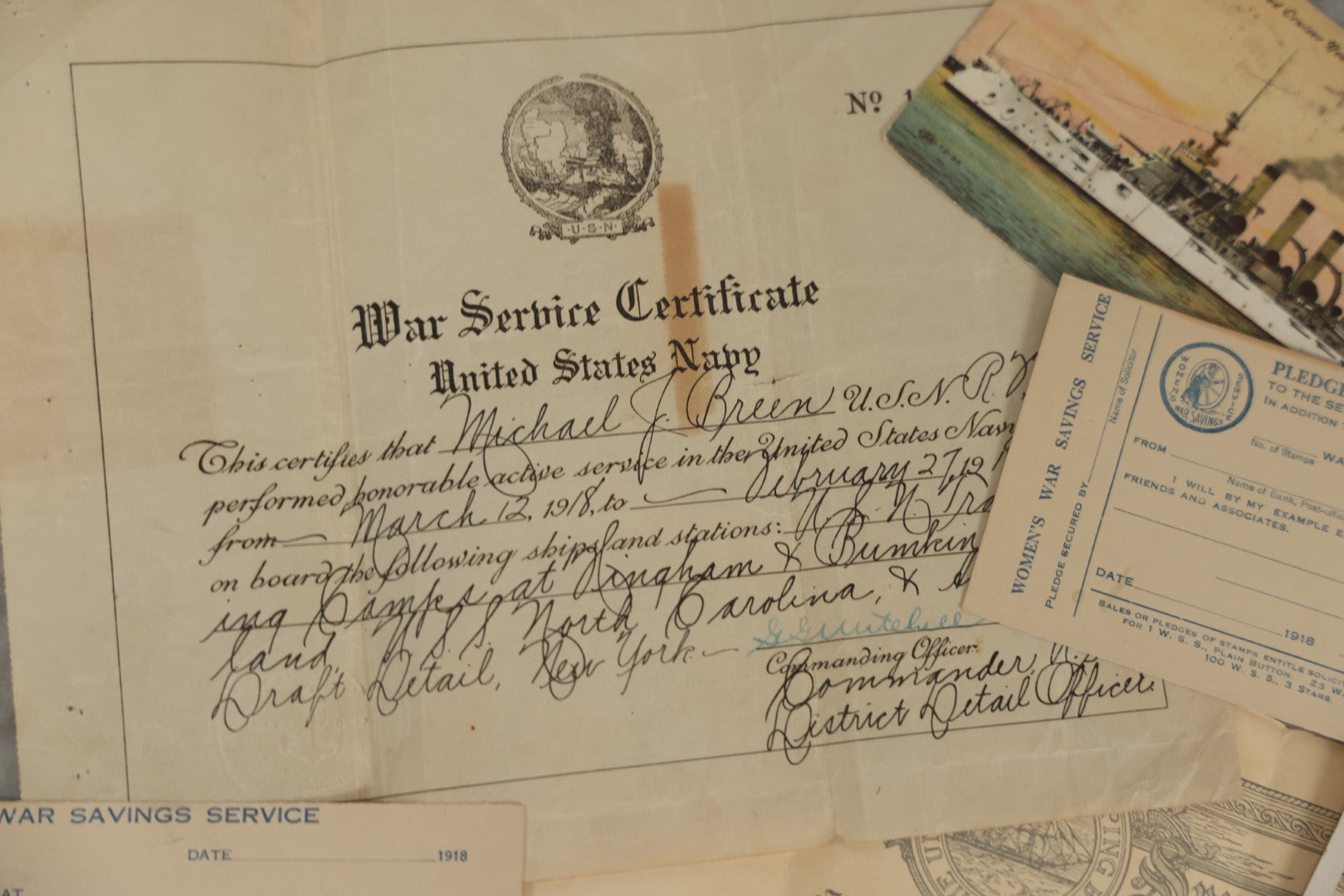 Lot 190 - Grouping Of Seven Antique World War I Related Ephemera Items Including Discharge Papers For John Joseph Breen And Michael J. Breen, Comic Postcard, And War Savings Stamps Forms, Circa 1910s–1920s