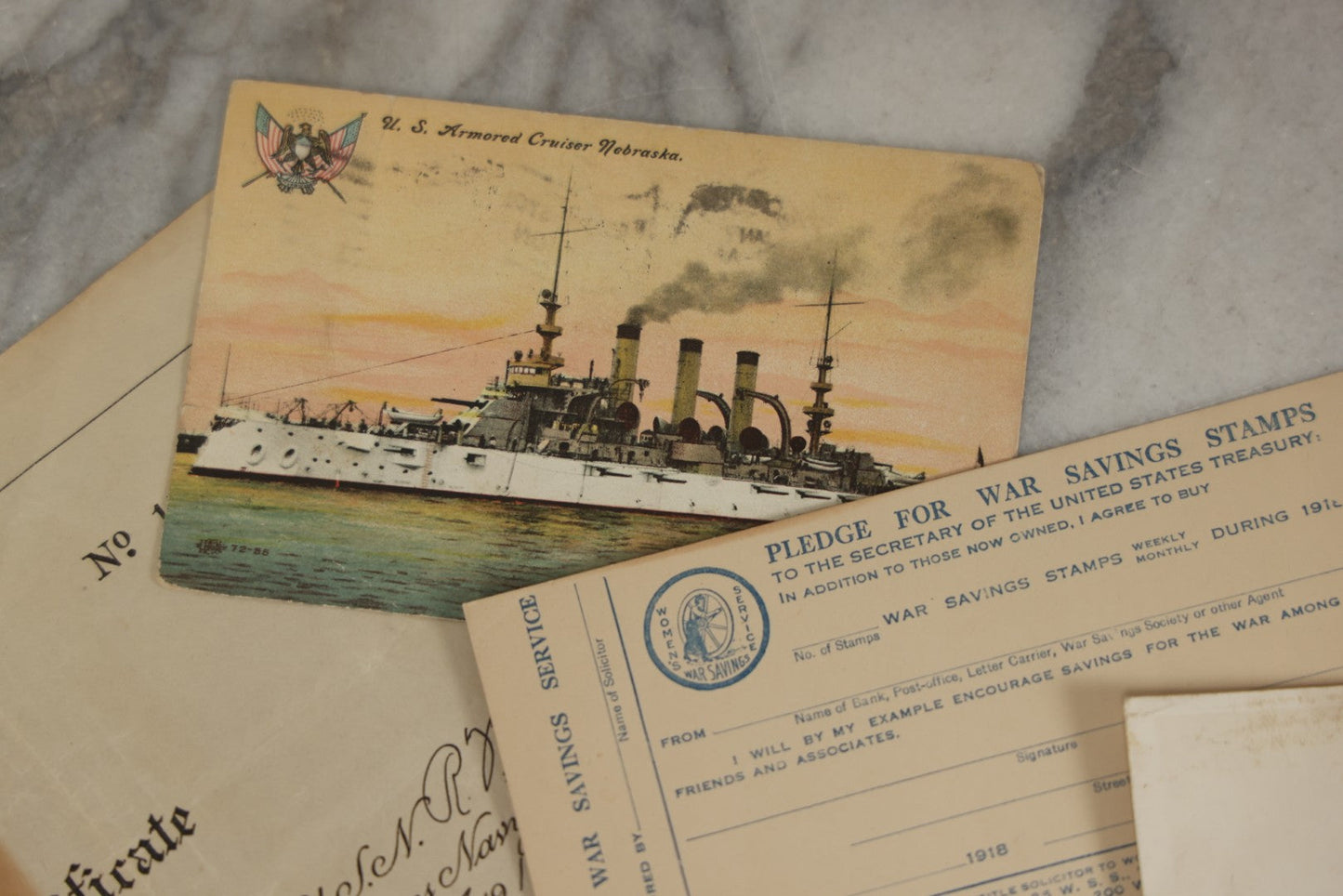 Lot 190 - Grouping Of Seven Antique World War I Related Ephemera Items Including Discharge Papers For John Joseph Breen And Michael J. Breen, Comic Postcard, And War Savings Stamps Forms, Circa 1910s–1920s