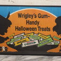 Lot 001 - Vintage Wrigley's Gum “Handy Halloween Treats” Crimped Paper Advertisement, Silhouetted Children In Costume, Blue, Orange & Black Colors, In Modern Metal Frame