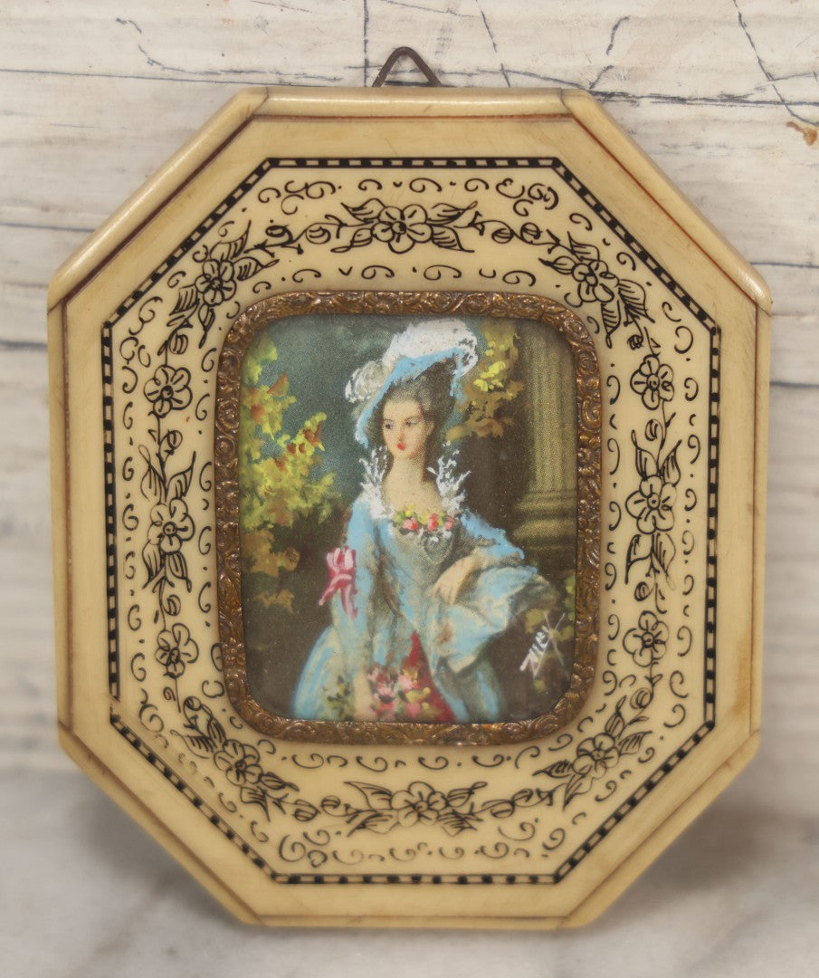 Lot 004 - Antique Miniature Print with Painted Details Of Fancy Woman In Blue, In Bone Frame, Signed "Zuley", With Brass Lip Around Glass, Fabric Cover On Verso, Frame Decorated With Painted Black Flower Border, 3" x 3-5/8"