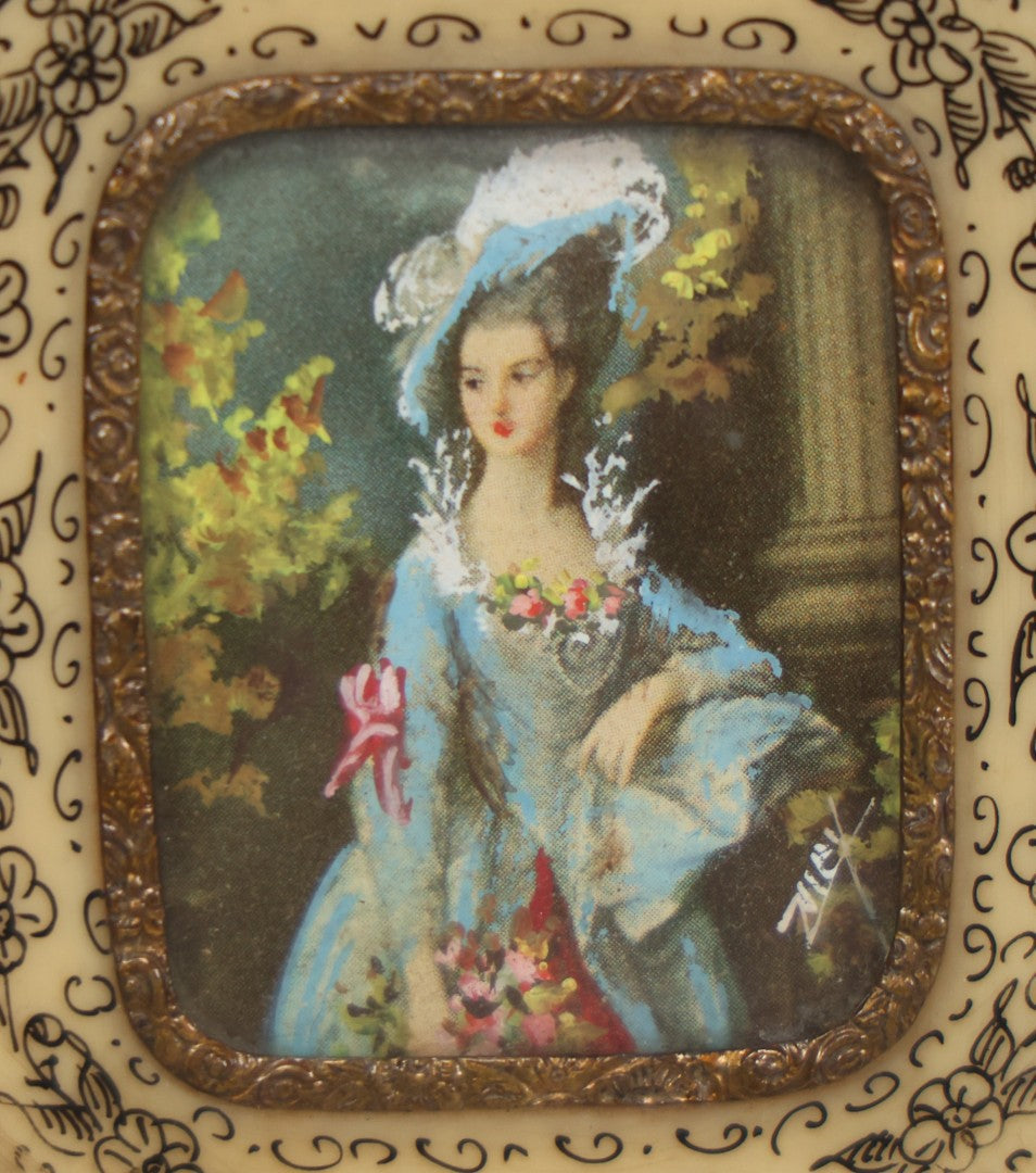 Lot 004 - Antique Miniature Print with Painted Details Of Fancy Woman In Blue, In Bone Frame, Signed "Zuley", With Brass Lip Around Glass, Fabric Cover On Verso, Frame Decorated With Painted Black Flower Border, 3" x 3-5/8"