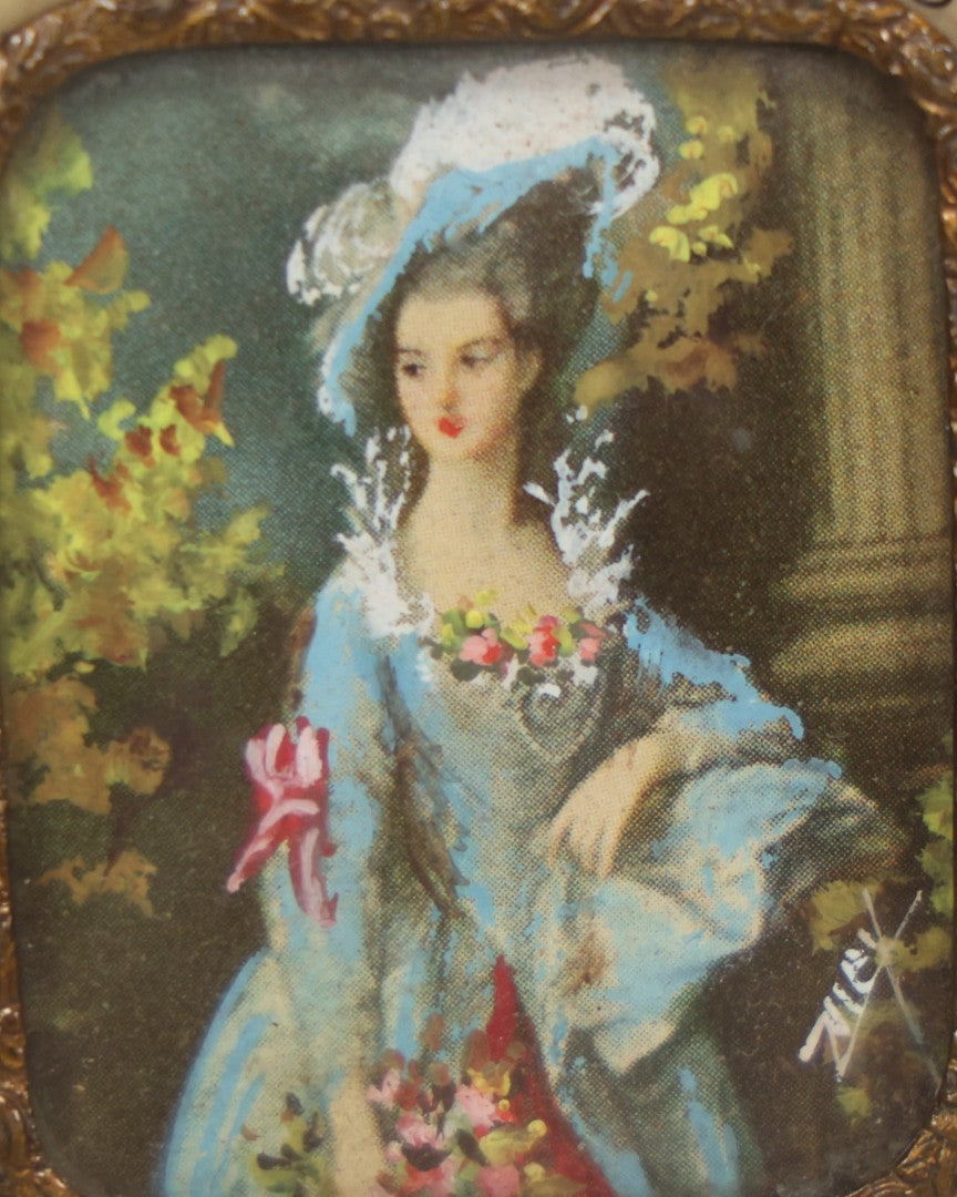 Lot 004 - Antique Miniature Print with Painted Details Of Fancy Woman In Blue, In Bone Frame, Signed "Zuley", With Brass Lip Around Glass, Fabric Cover On Verso, Frame Decorated With Painted Black Flower Border, 3" x 3-5/8"