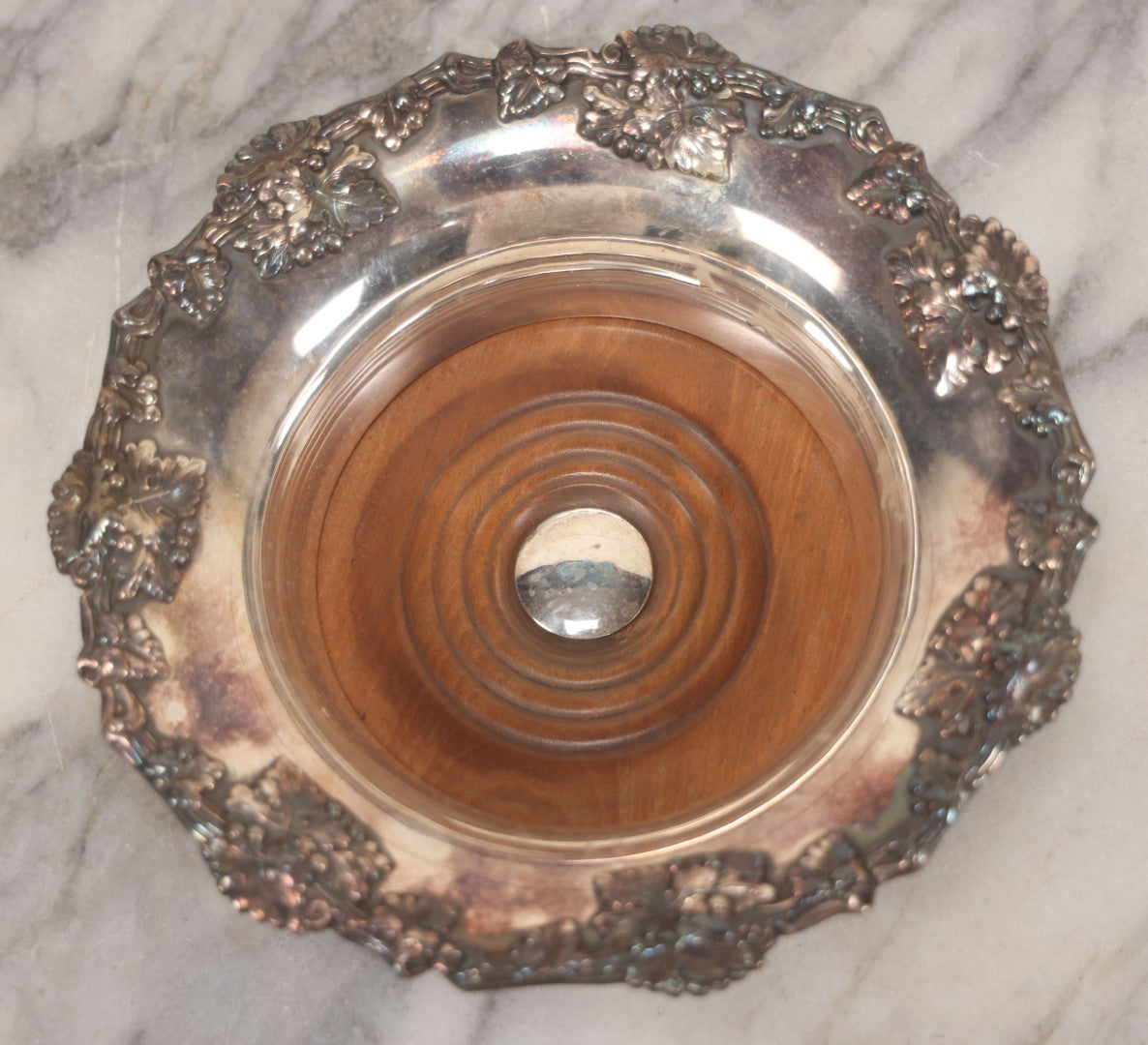Lot 019 - Vintage Silverplate Dish With Turned Wood Base, Felt Bottom, Grape Leaf And Vine Motif Around Rim, 8" Diameter