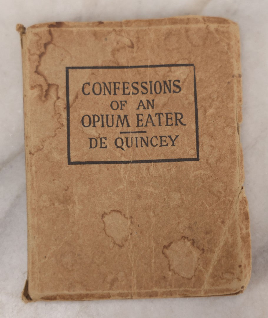 Lot 041 - Grouping Of Two Miniature Narrow Clear Glass Bottles And "Confessions Of An Opium Eater" Antique Miniature Book With Paper Cover And Advertising For Whitman's Candy In Rear, Published By Little Leather Library Corporation, New York, Circa 1920