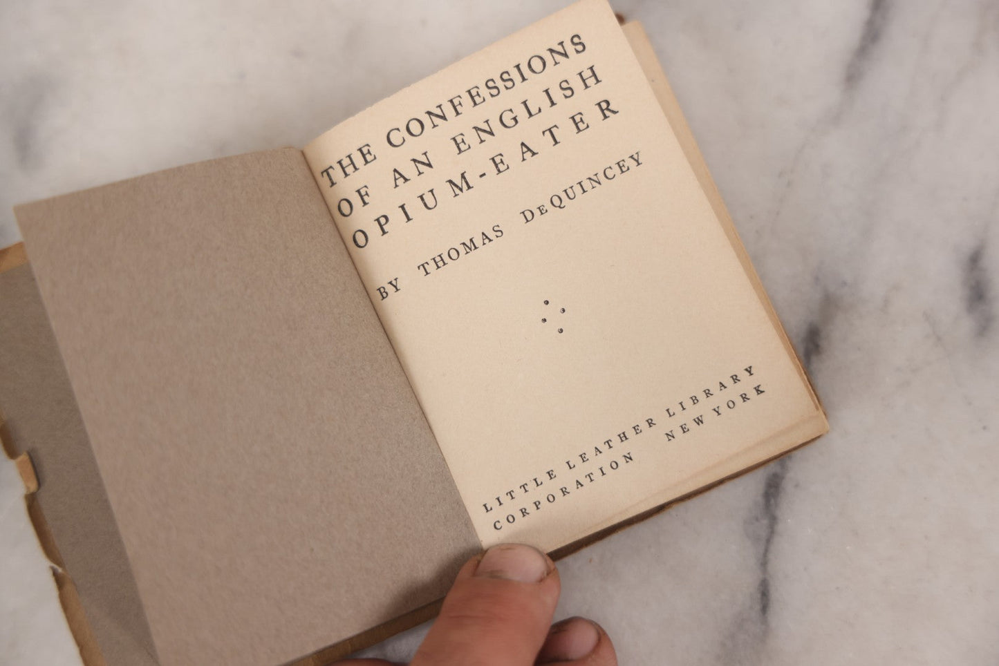 Lot 041 - Grouping Of Two Miniature Narrow Clear Glass Bottles And "Confessions Of An Opium Eater" Antique Miniature Book With Paper Cover And Advertising For Whitman's Candy In Rear, Published By Little Leather Library Corporation, New York, Circa 1920