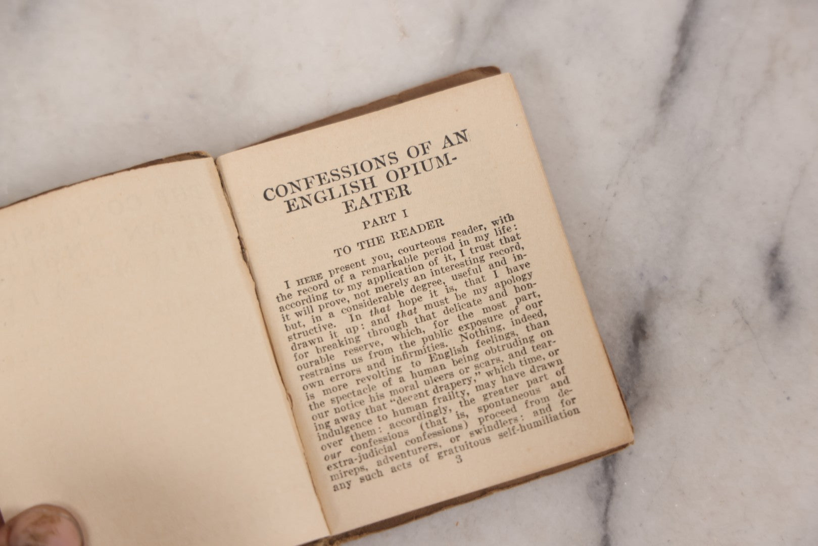 Lot 041 - Grouping Of Two Miniature Narrow Clear Glass Bottles And "Confessions Of An Opium Eater" Antique Miniature Book With Paper Cover And Advertising For Whitman's Candy In Rear, Published By Little Leather Library Corporation, New York, Circa 1920