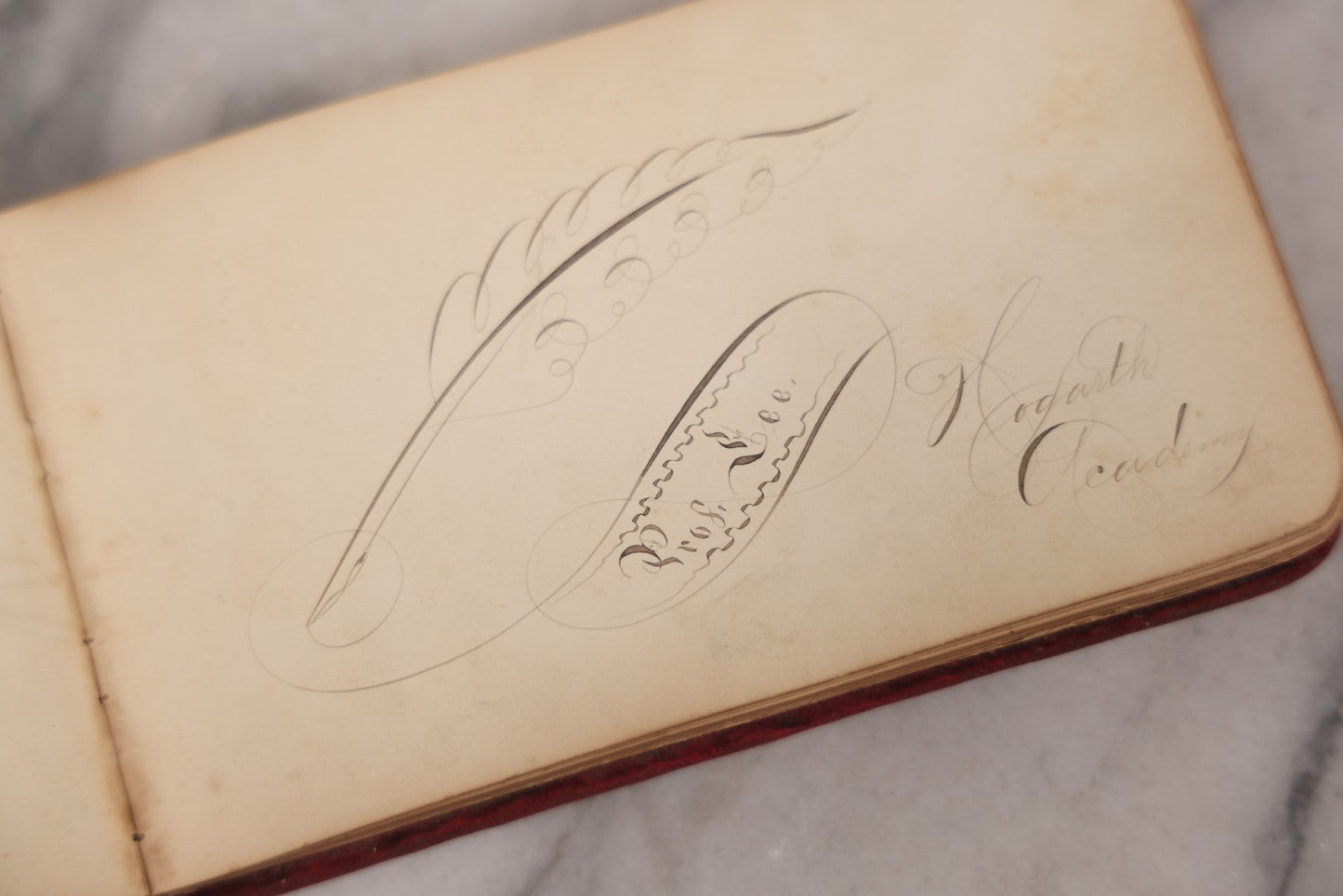 Lot 055 - Antique Victorian Red Velvet Autograph Album Of Lizzie, Hogarth Academy, Connecticut, 1880s With Student & Teacher Signatures, Hand-Drawn Comic Pencil Sketch, Die-Cut Lithographs & Painted Floral Page