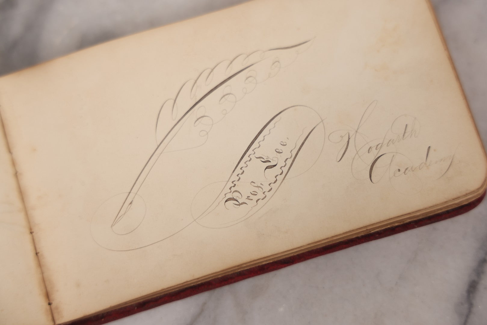 Lot 055 - Antique Victorian Red Velvet Autograph Album Of Lizzie, Hogarth Academy, Connecticut, 1880s With Student & Teacher Signatures, Hand-Drawn Comic Pencil Sketch, Die-Cut Lithographs & Painted Floral Page