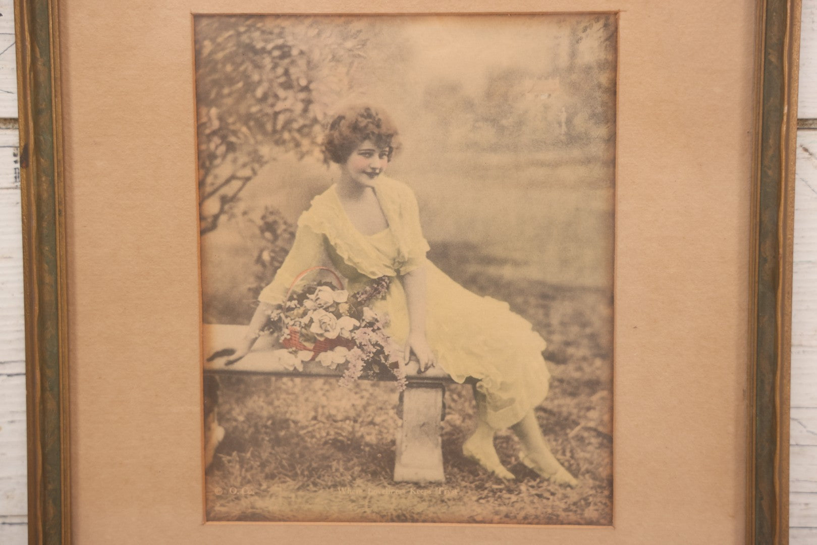 Lot 058 - Antique Framed Hand-Tinted Art Photo Print, "Where Loveliness Keeps Tryst," Featuring Woman In Yellow Dress On Bench With Flowers, Copyright O. Co., 11-1/2" x 13"