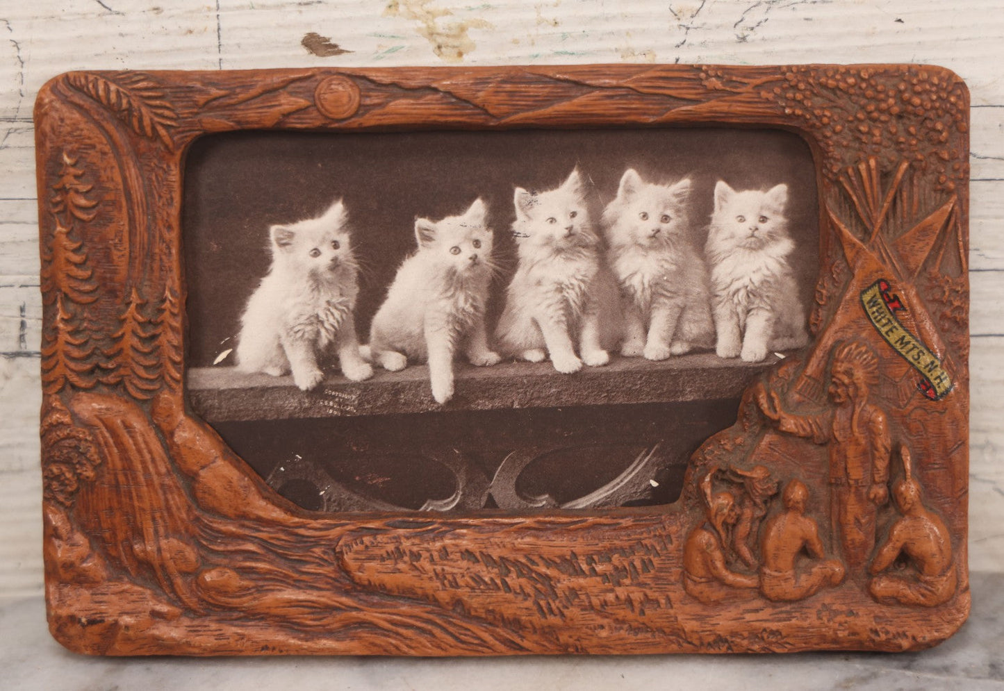 Lot 064 - Antique Molded Composite Photo Frame With Native American Motif, Souvenir Of White Mountains, New Hampshire, With Black And White Photo Postcard Of Five Kittens, 7-3/8" x 4-5/8"