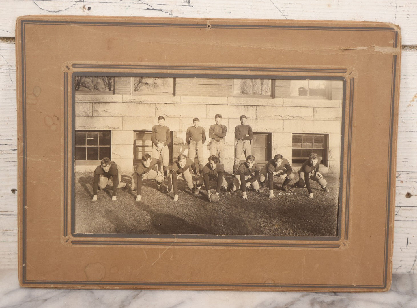 Lot 065 - Vintage Paper Framed Glossy Black And White Photo Of North Dakota State College Football Team, 1937, Featuring Jack Stevens