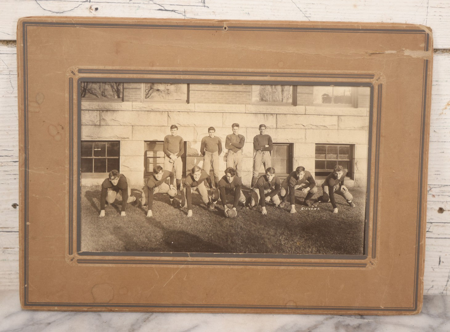 Lot 065 - Vintage Paper Framed Glossy Black And White Photo Of North Dakota State College Football Team, 1937, Featuring Jack Stevens
