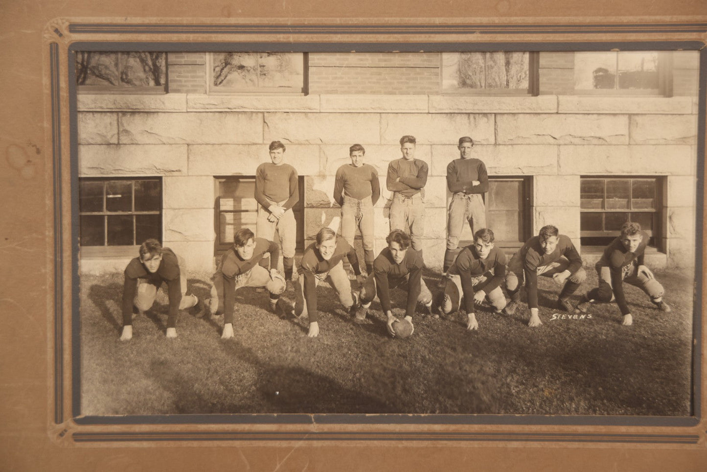 Lot 065 - Vintage Paper Framed Glossy Black And White Photo Of North Dakota State College Football Team, 1937, Featuring Jack Stevens
