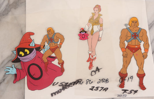 Lot 079 - Grouping Of Five Original Reverse-Painted Production Character Animation Cels On Celluloid From 1983 Cartoon "He-Man And The Masters Of The Universe," He-Man (2), Orko (2), And Teela (1)