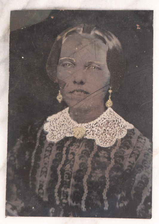 Lot 103 - Antique Tintype Photograph Of Woman With A Toothy, Stoic Expression, Hand-Painted Details, Slightly Smaller Than Half Plate
